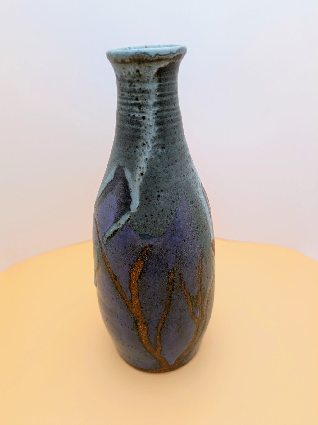 Narrow-neck vase, purple and greenish hues with bare clay accents