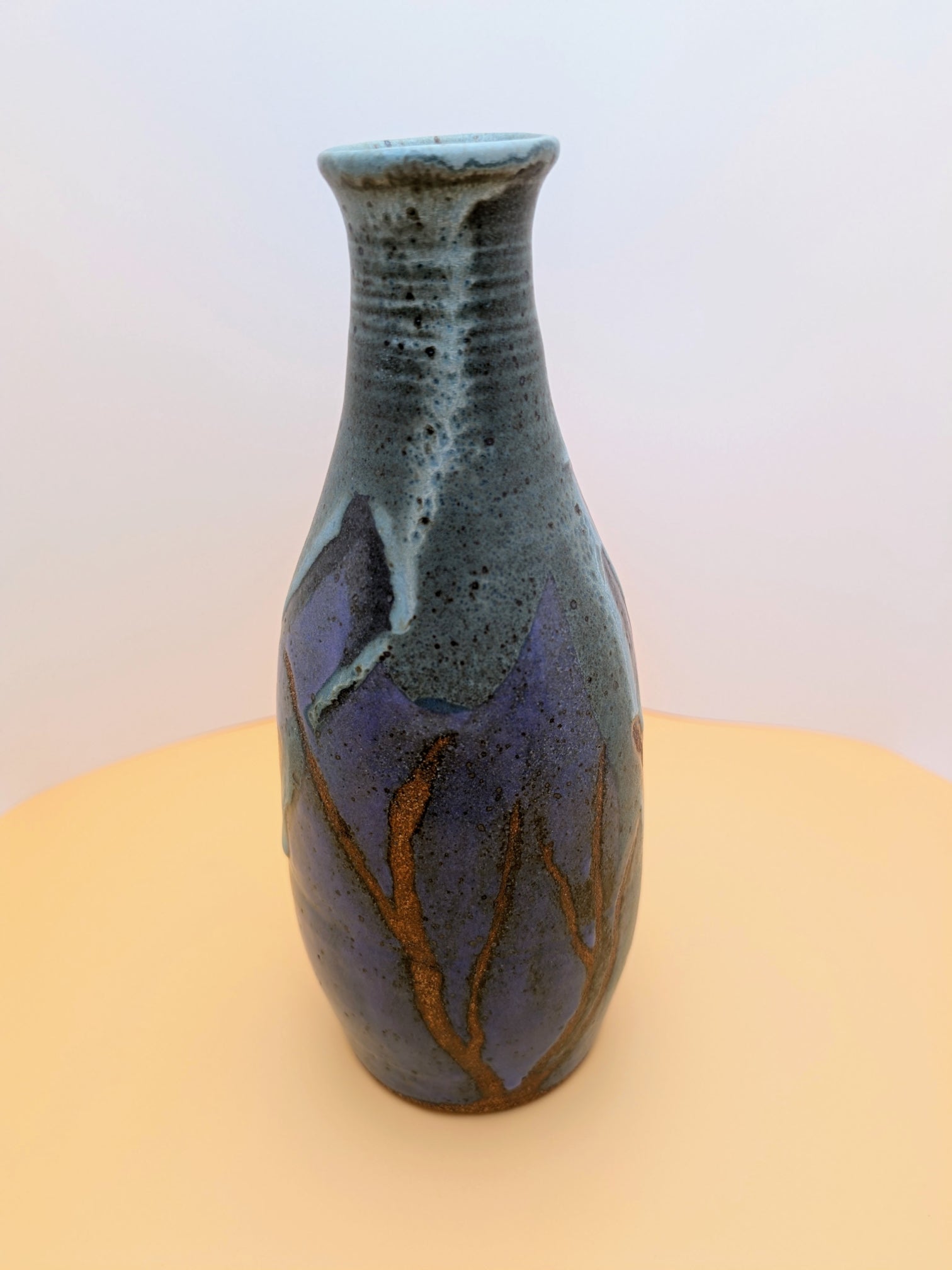 Narrow-neck vase, purple and greenish hues with bare clay accents
