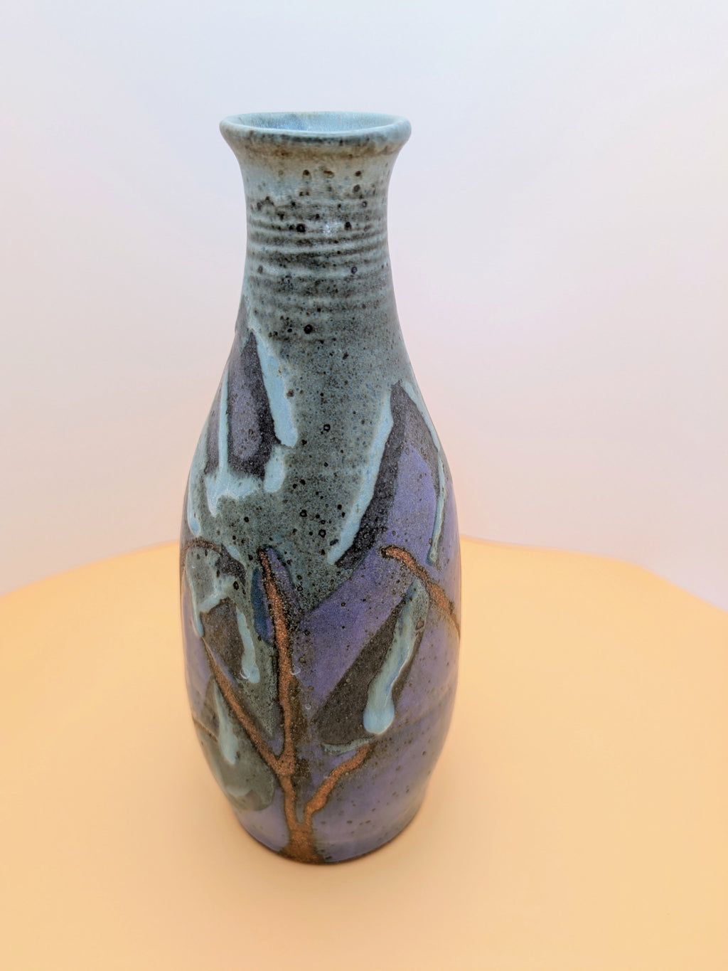 Narrow-neck vase, purple and greenish hues with bare clay accents