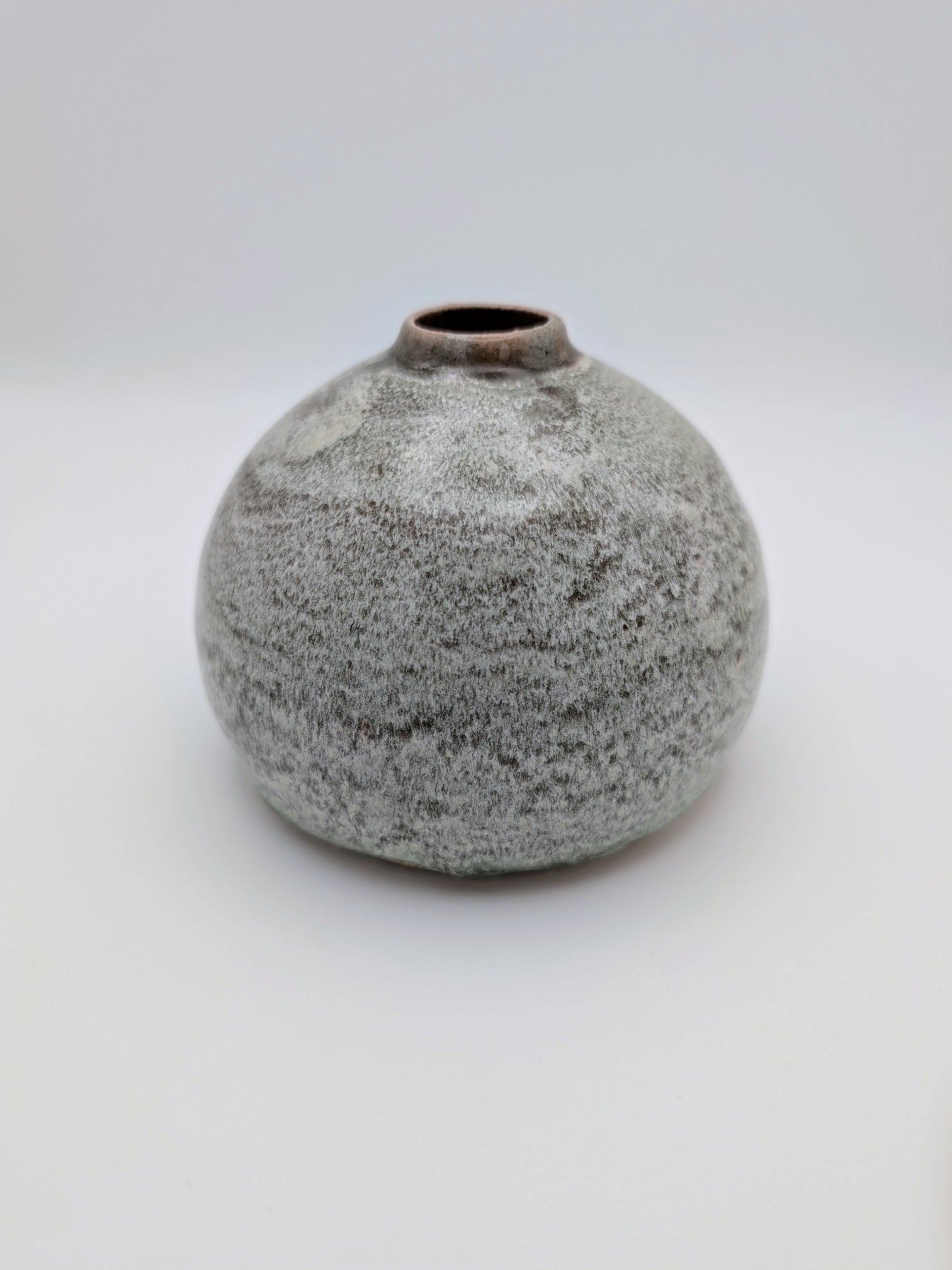 Short, bulbous vase with thick, complex glaze effects