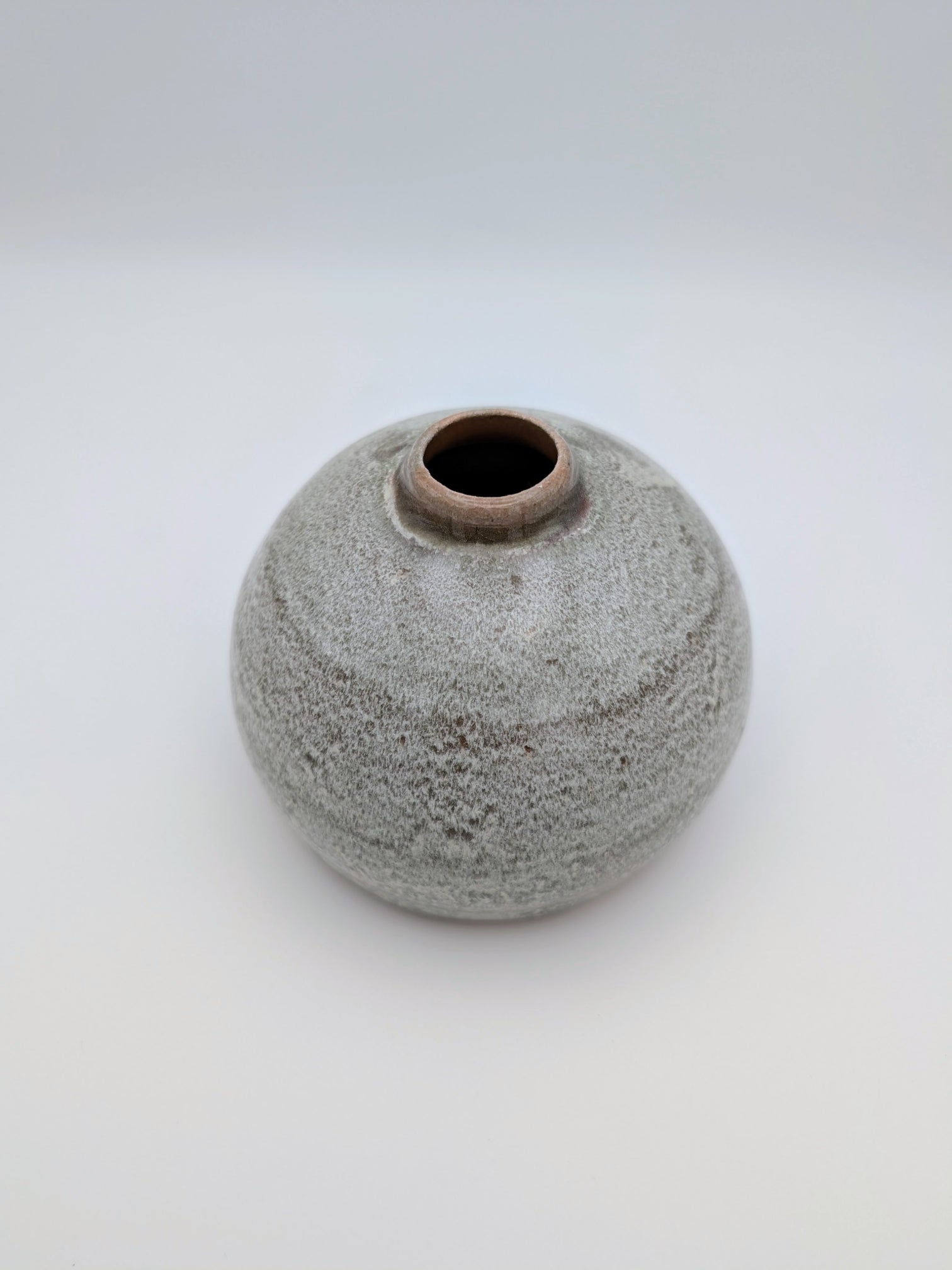 Short, bulbous vase with thick, complex glaze effects