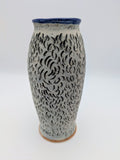 Elegant blue-lined vase with textured, matte exterior