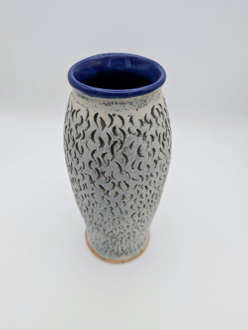 Elegant blue-lined vase with textured, matte exterior